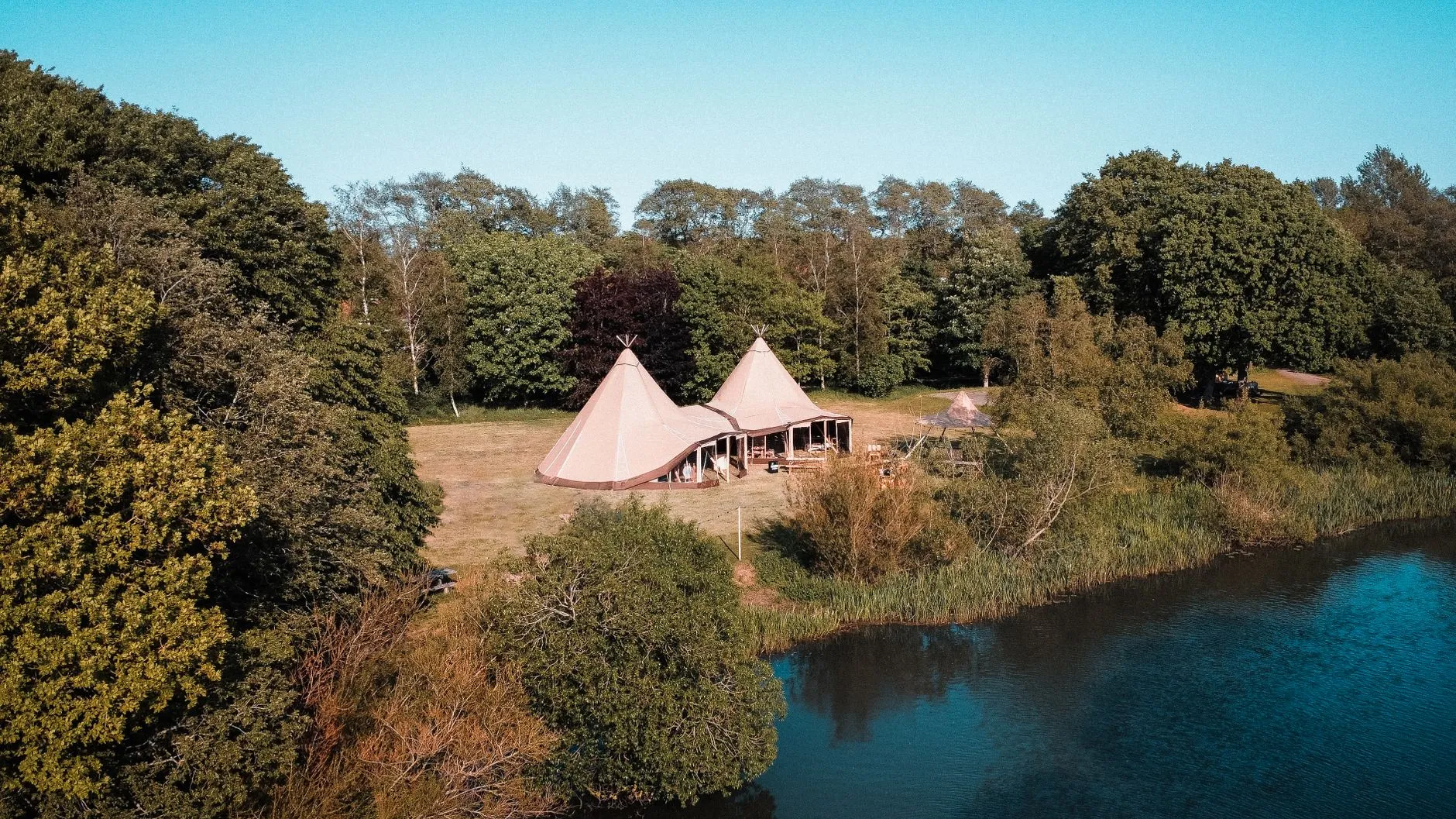 A calm lake in the Welsh countryside at a rural venue